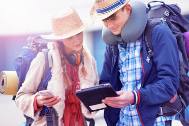 Backpacker couple using digital tablet - CUF46575