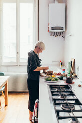 Woman preparing food in kitchen - CUF46668