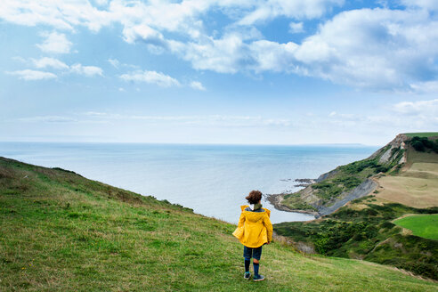 Boy on clifftop looking out to sea, Bournemouth, UK - CUF46722