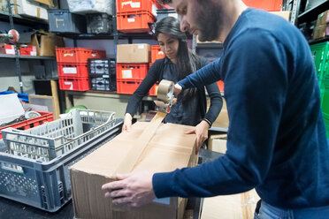 Colleagues working on delivery and packaging in warehouse - CUF46739