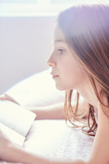 Girl reading book and day dreaming - CUF46763