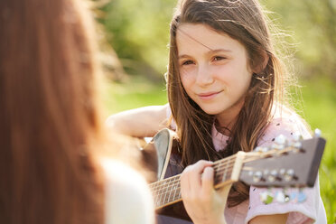 Girl playing guitar - CUF46783