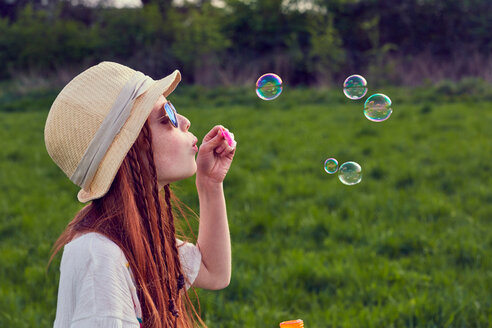 Girl playing with soap bubbles - CUF46787