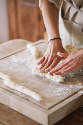 Woman preparing dough for gnocchi - CUF46850