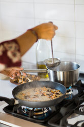 Making mushroom risotto - CUF46881