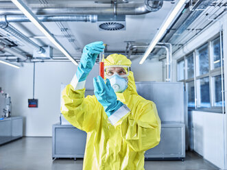 Chemist working in industrial laboratory, checking test tube - CVF01089