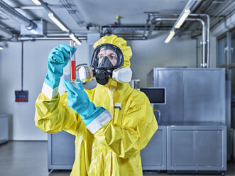 Chemist working in industrial laboratory, checking test tube - CVF01090