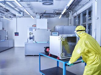 Chemist working in industrial laboratory clean room - CVF01095