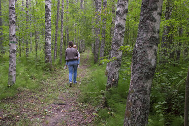 Finnland, Kuopio, Mutter und Tochter spazieren in einem Birkenwald - PSIF00209