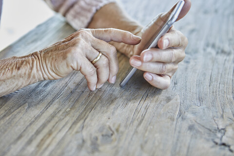 Woman's hands using smartphone, close-up stock photo