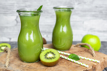 Two glass bottles of apple kiwifruit smoothie - SARF04049