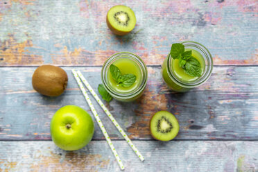 Two glass bottles of apple kiwifruit smoothie - SARF04050