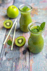 Two glass bottles of apple kiwifruit smoothie - SARF04051