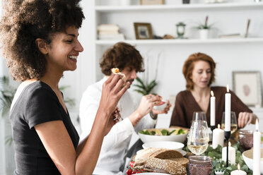 Friends having fun at a dinner party, enjoying eating together - ERRF00562