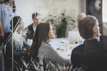 Creative business people listening while sitting in conference room - MASF10733