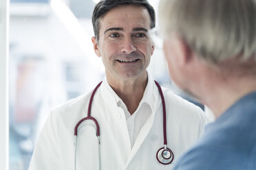 Portrait of smiling doctor looking at patient - JOSF02787