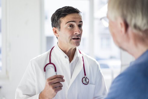 Portrait of doctor and talking to patient in medical practice - JOSF02821