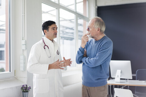Doctor and patient talking in medical practice stock photo