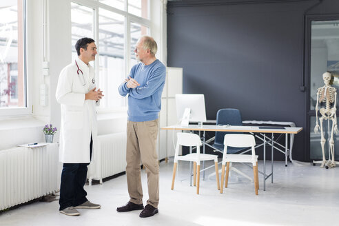 Doctor and patient standing face to face in medical practice - JOSF02824