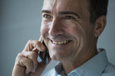 Portrait of smiling businessman on cell phone - JOSF02827