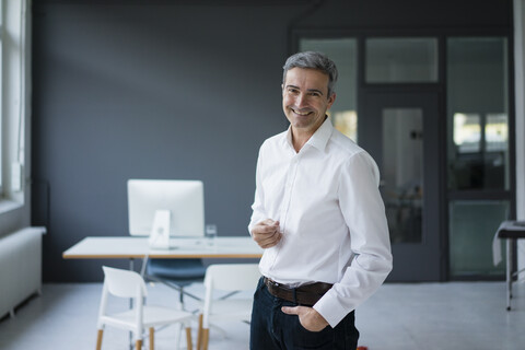 Portrait of smiling businessman in the office stock photo