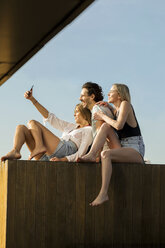 Freunde haben Spaß auf einer Dachterrasse und machen Selfies - VABF02120