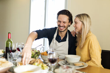 Friends having fun, eating lunch together, couple flirting at the table - VABF02143