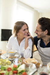 Freunde, die sich amüsieren, gemeinsam zu Mittag essen, ein flirtendes Paar am Tisch - VABF02144