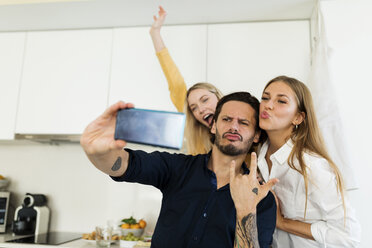 Freunde, die Spaß daran haben, in der Küche zu stehen und Fotos mit ihren Smartphones zu machen - VABF02164
