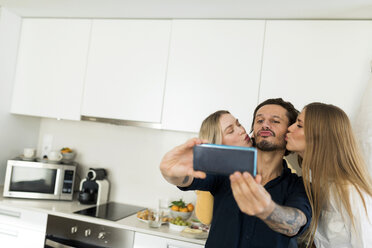 Freunde, die Spaß daran haben, in der Küche zu stehen und Fotos mit ihren Smartphones zu machen - VABF02165