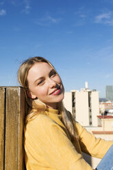 Young woman relaxing on an urban rooftop terrace - VABF02207