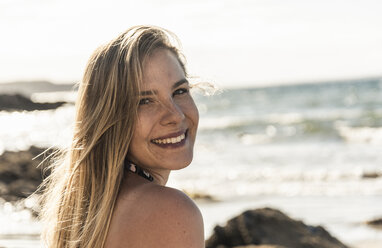 Portrait of a happy young oman on the beach - UUF16486