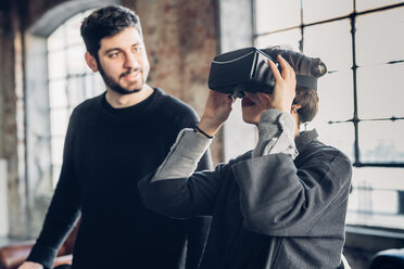 Designers testing virtual reality headset in studio - CUF47234