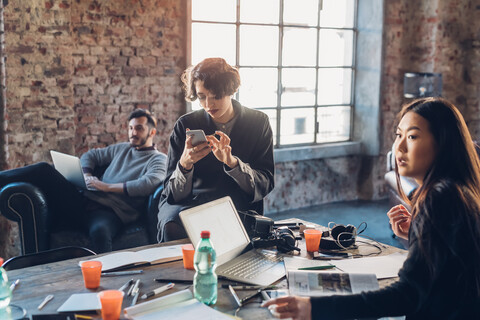 Designers brainstorming in communal space in studio stock photo