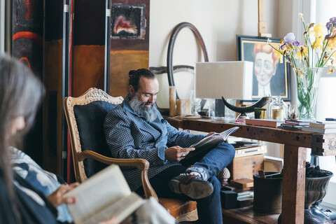 Couple reading in room stock photo