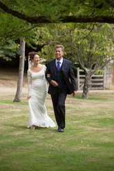 Father walking daughter to wedding - CUF47457