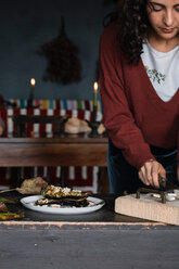 Young woman slicing food on chopping board, cropped - CUF47565