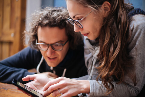 Couple using smartphone in cafe stock photo