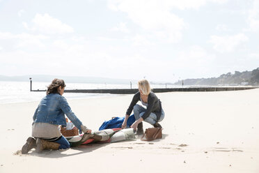 Sisters leaving after picnic on beach - CUF47712