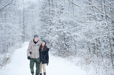Romantisches junges Paar bei einem Spaziergang im verschneiten Wald, Ontario, Kanada - CUF47825