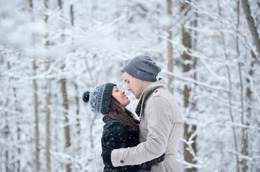 Romantisches junges Paar von Angesicht zu Angesicht im verschneiten Wald, Ontario, Kanada - CUF47826