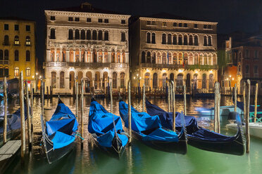 Gondolas on Grand canal waterfront at night, Venice, Veneto, Italy - CUF47889