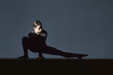 Woman dressed in black doing stretching exercise - VGF00188