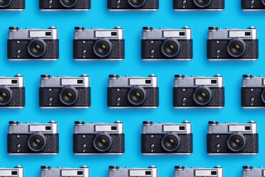 Photo cameras organized in a row over blue background - DRBF00130