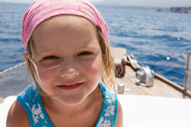 Cute girl on boat wearing headscarf, portrait, Castellammare del Golfo, Sicily, Italy - CUF47907