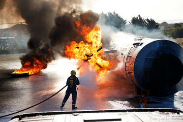 Firemen putting out fire on old training aeroplane, Darlington, UK - CUF48140