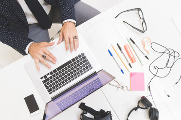 Businessman using laptop on office desk, overhead view - CUF48225