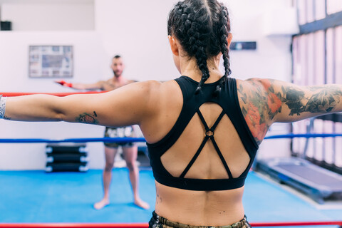 Male and female boxers working out in boxing ring stock photo