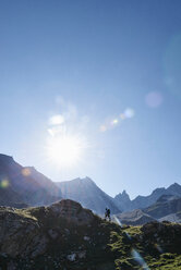 Hiker going up to peak of rock, Mont Cervin, Matterhorn, Valais, Switzerland - CUF48442