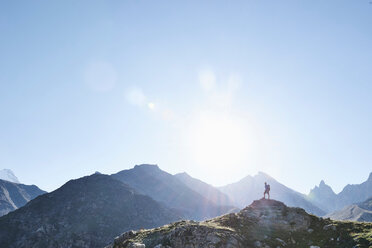 Hiker on peak of rock, Mont Cervin, Matterhorn, Valais, Switzerland - CUF48443